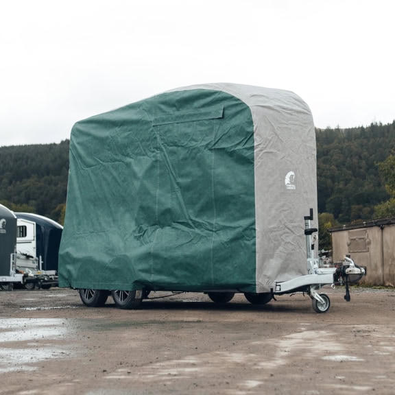 An image of a bespoke fitting Horsebox cover in green and grey.