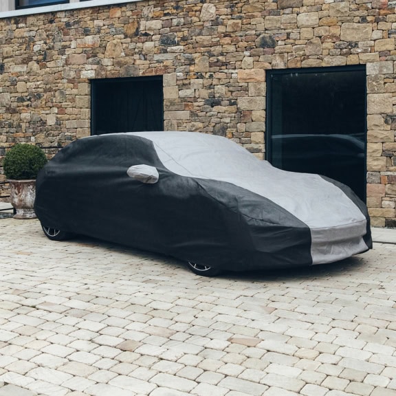A bespoke fit outdoor car cover in black and grey on a Porsche.