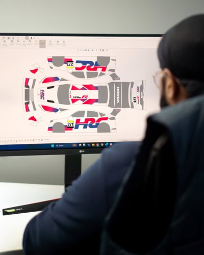 An image of the 3D Design team working on the printed panels of a cover.