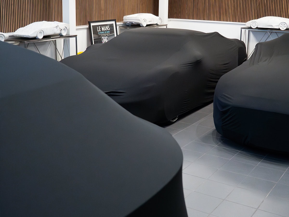 An image of multiple cars in storage with Indoor Lite covers on.