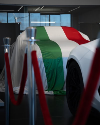 A picture of a Lamborghini with an Indoor Reveal with a printed Italian Flag