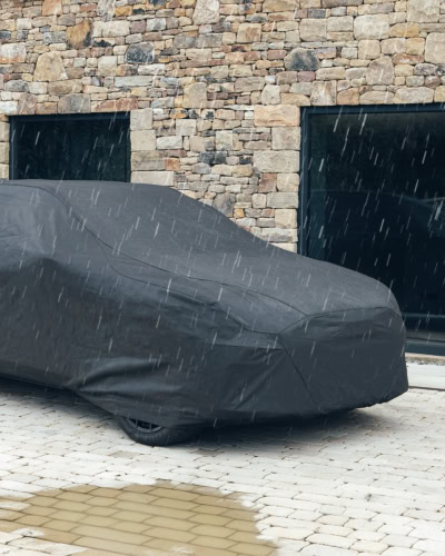 An image of a Outdoor Pro cover in the rain protecting a car.