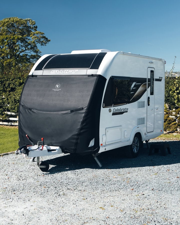 A caravan with a Tow Pro Plus cover on the front.