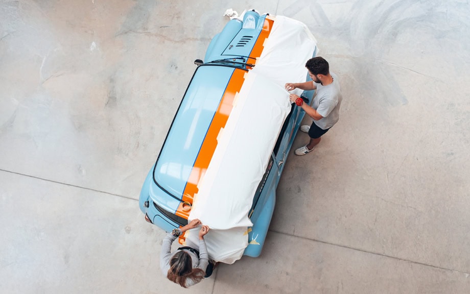 A picture of the Specialised Covers Design team working on a pattern for a car cover for a classic mini.