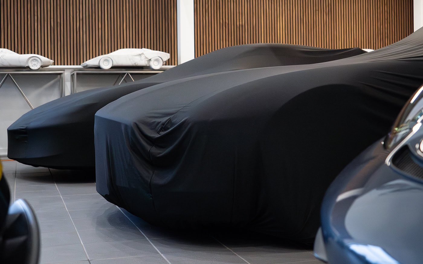 Two cars with universal fit indoor car covers on.