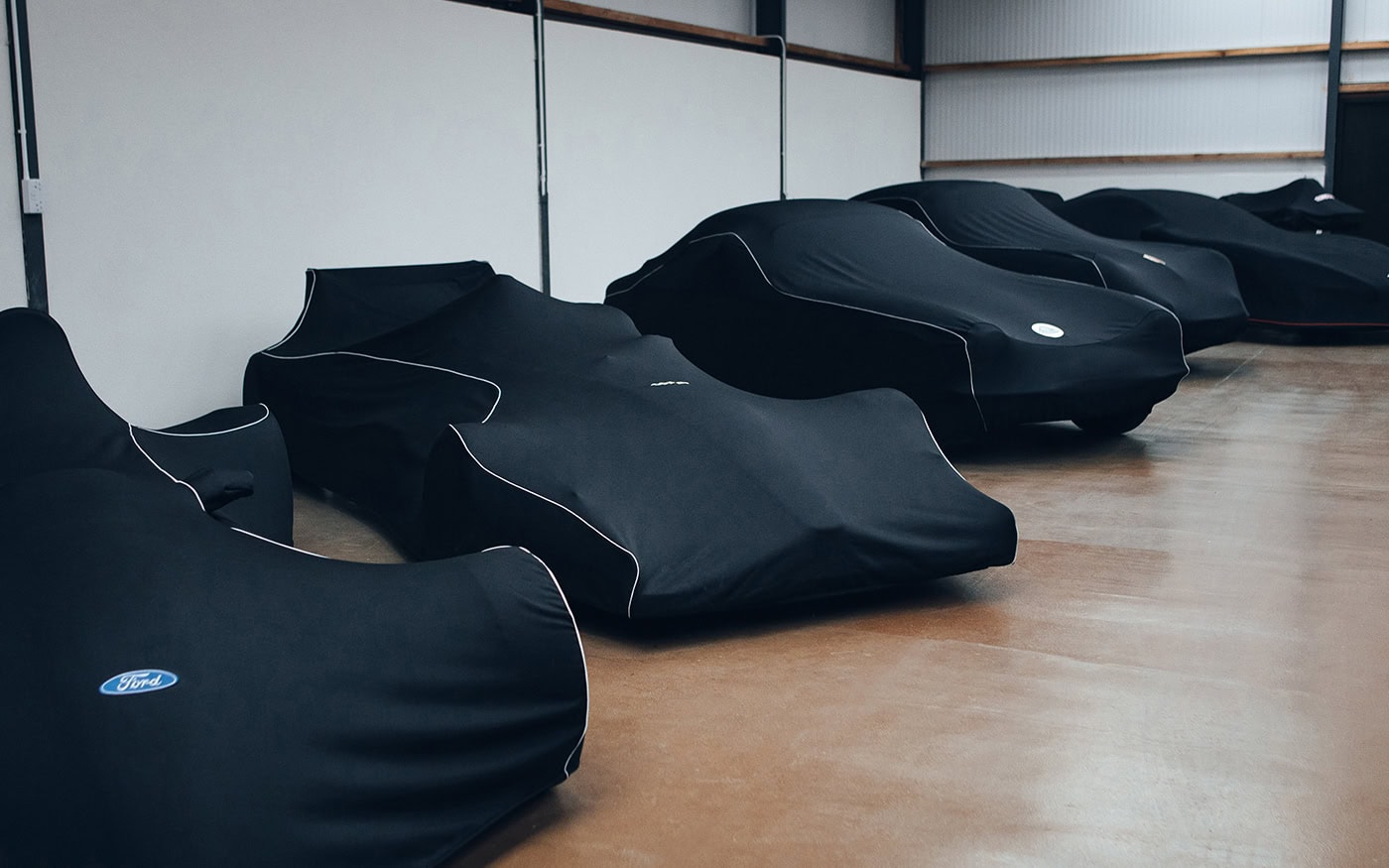 A collection of cars with Indoor Pro covers on in matching specifications.
