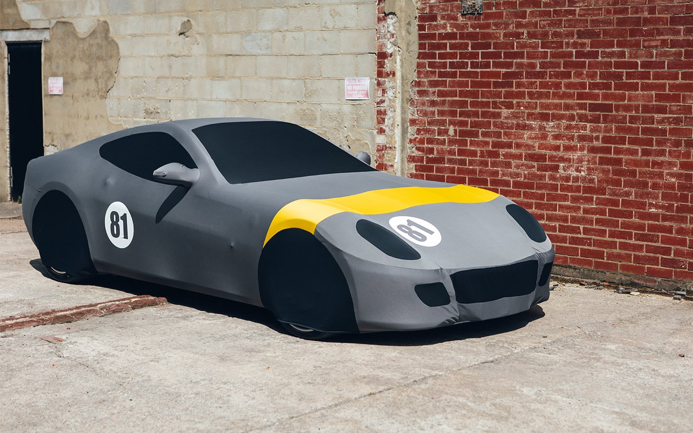 An Indoor Silhouette car cover on a Ferrari with a racing livery.
