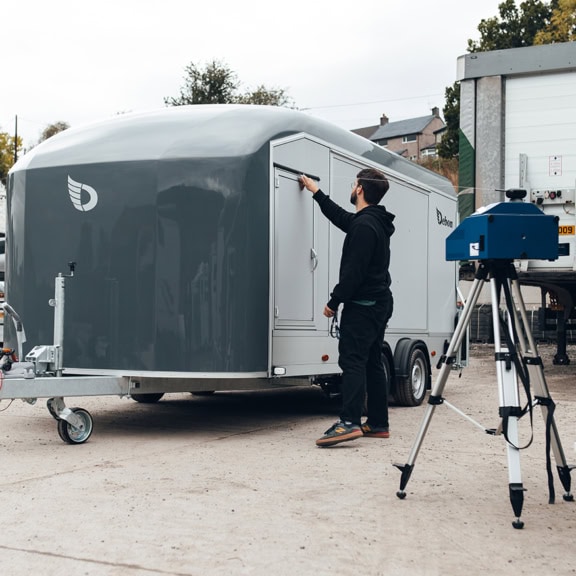 A picture of our 3D design team, 3D scanning a vehicle.