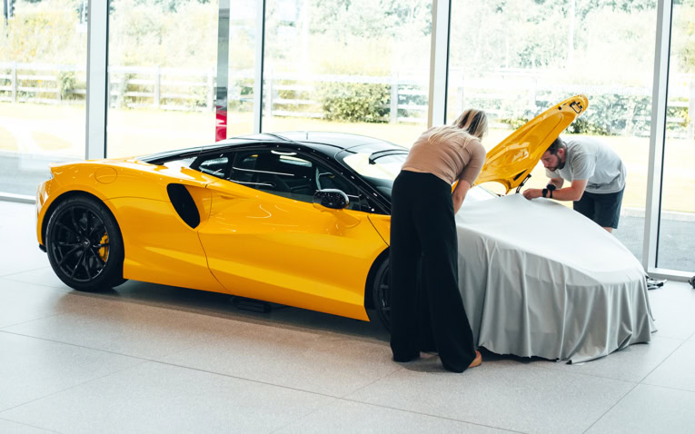 A picture of our design team working on a Mclaren car cover.