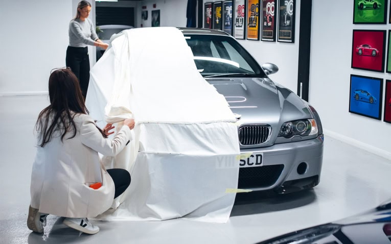 An image of our design team tailoring a cloth pattern on a BMW m3