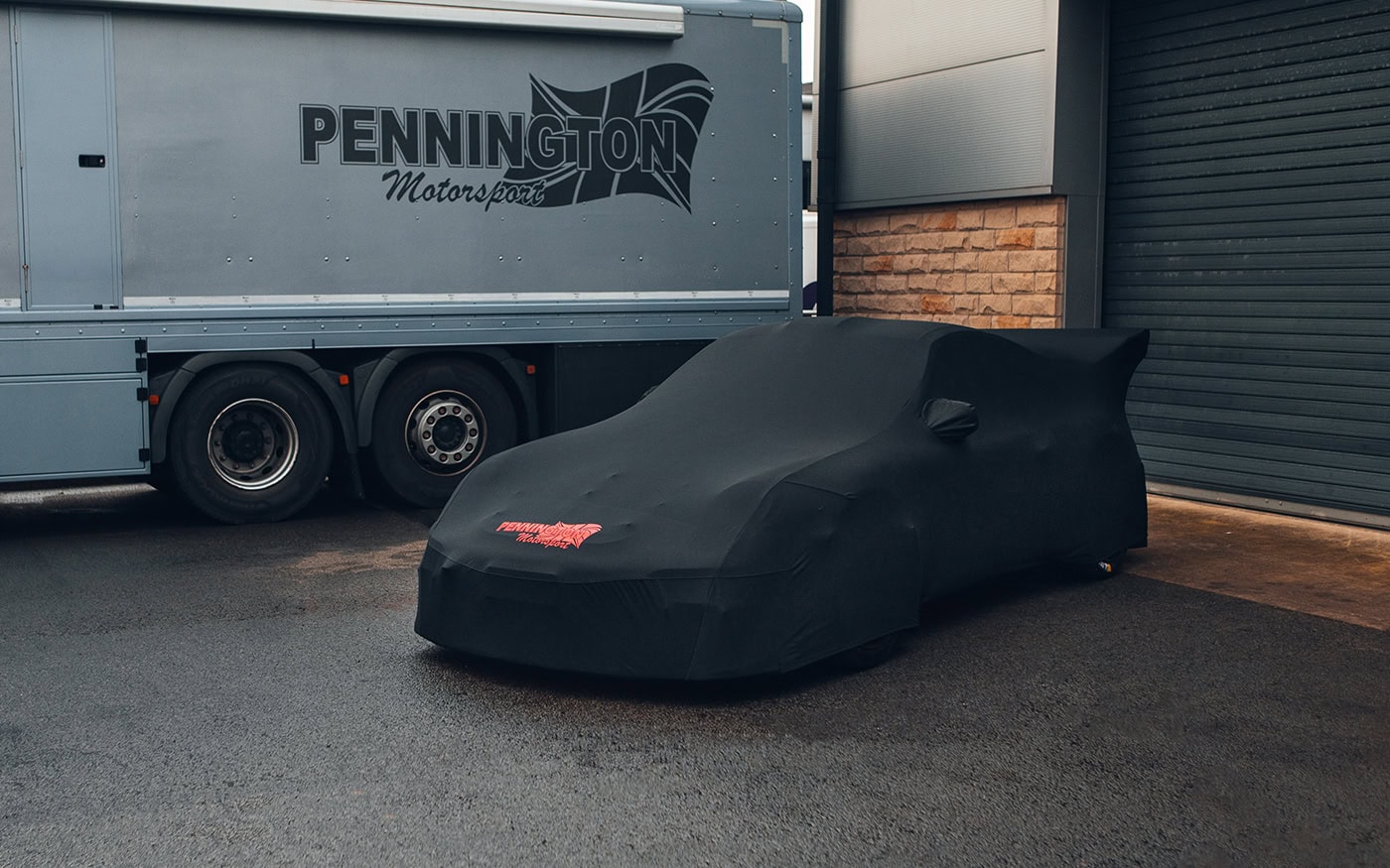 A picture of a porsche racecar outside with an Indoor Elite car cover on.