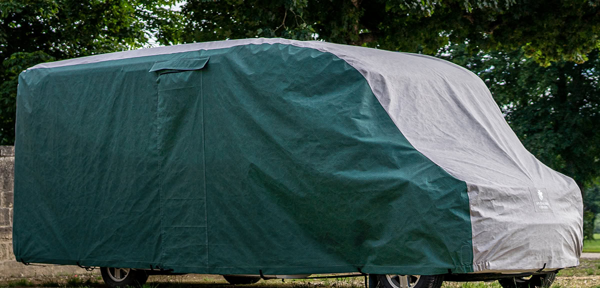 An image of a bespoke fit motorhome cover in green and grey.