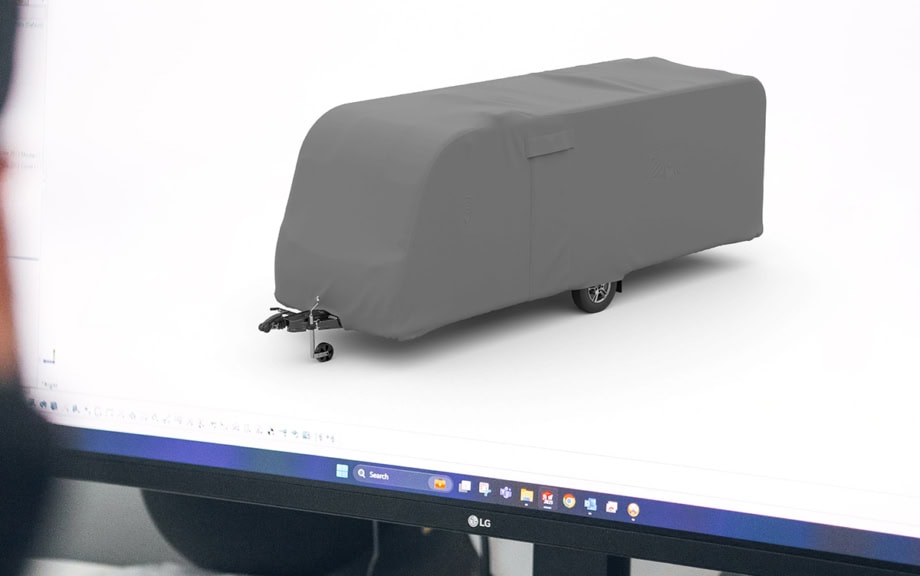 A picture of a 3D designer with a model of a Caravan Cover
