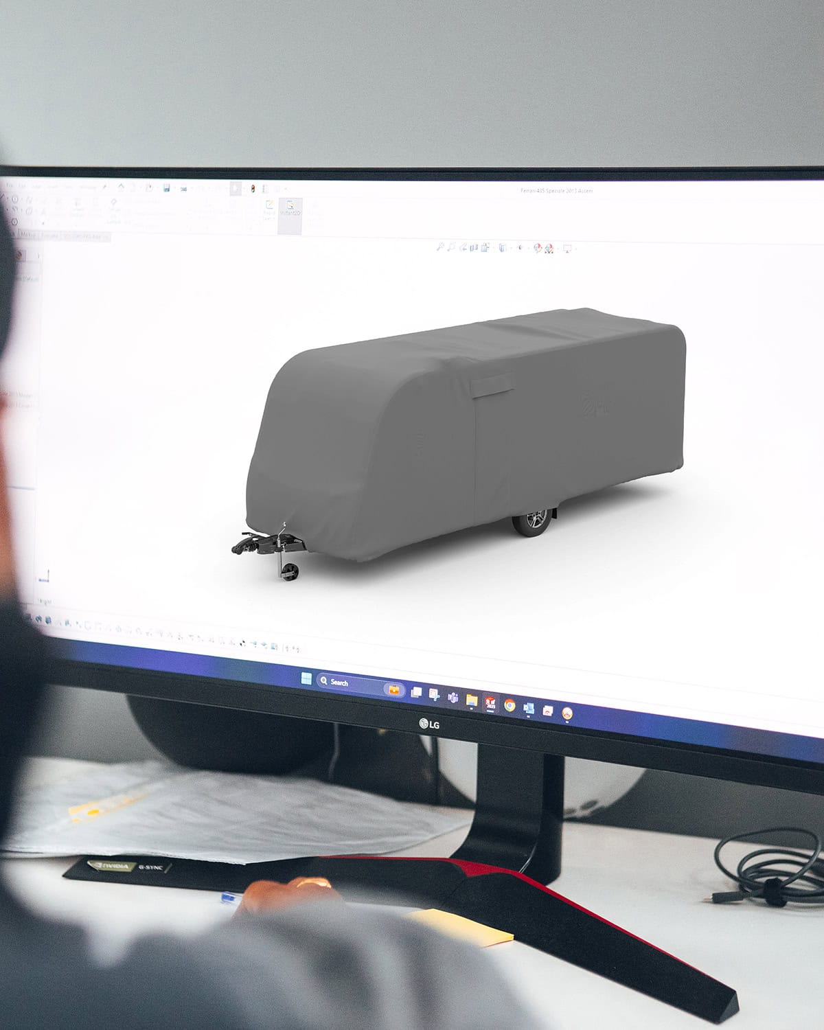 A picture of a 3D designer with a model of a Caravan Cover