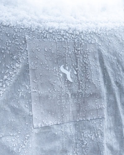 A close up of the torrent fabric with frozen icicles and snow on it.