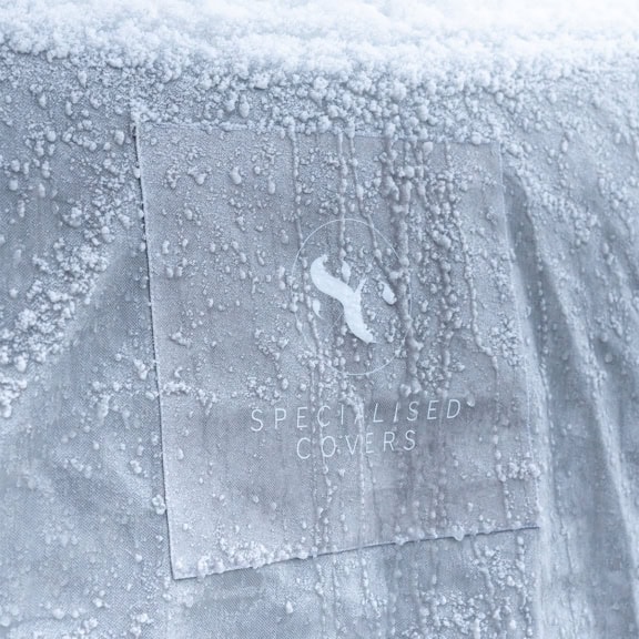 A close up of the torrent fabric with frozen icicles and snow on it.