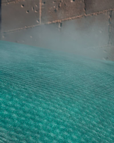 Steam rising through a breathable outdoor cover.